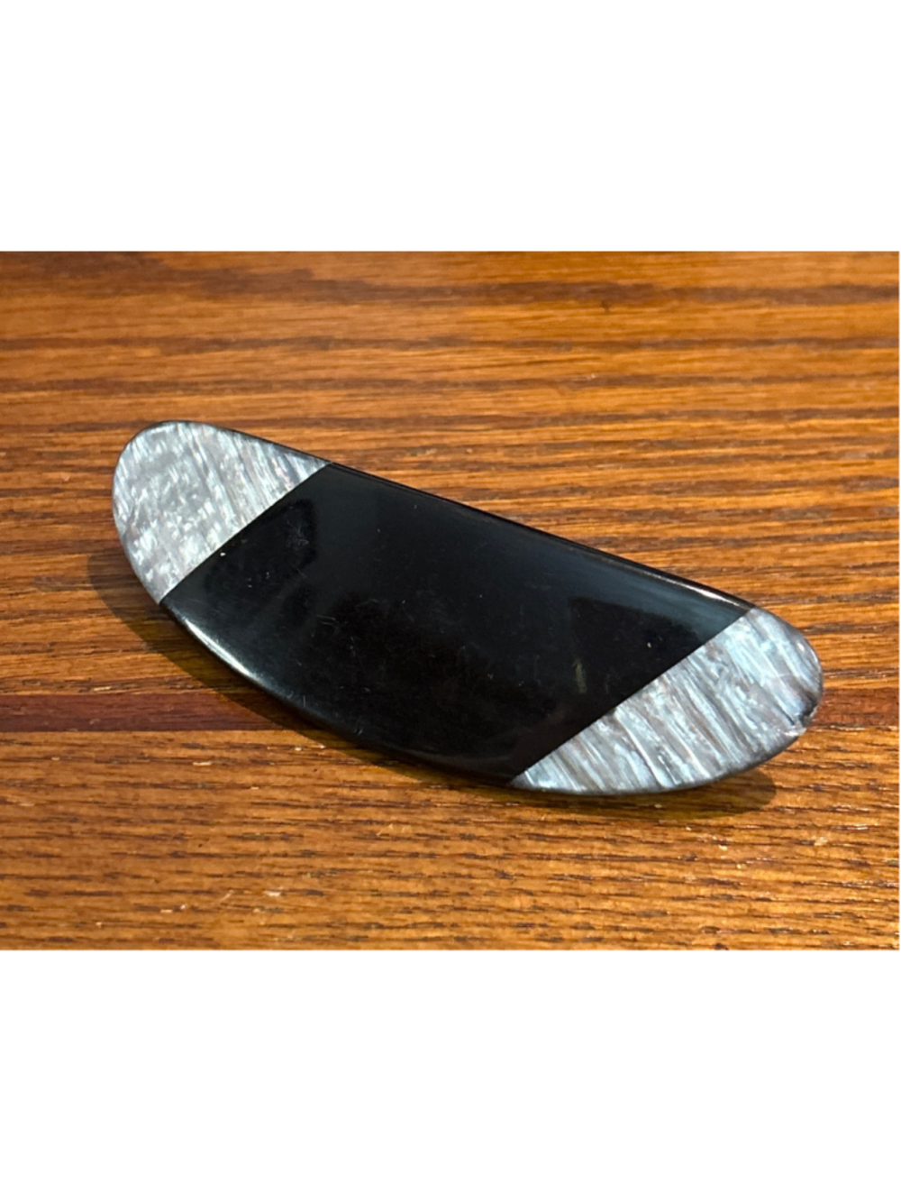 Women's curved black and pearlescent acrylic hair barrette